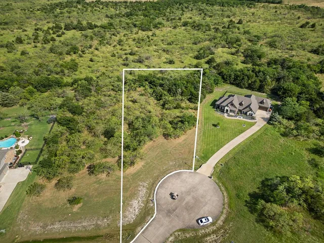 an aerial view of a residential houses with outdoor space