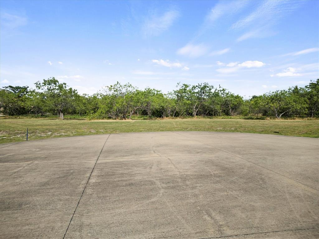 540 Austin Circle, Unit B Terrell, TX 75160 - Photo 11 of 11 a view of a field with trees in background