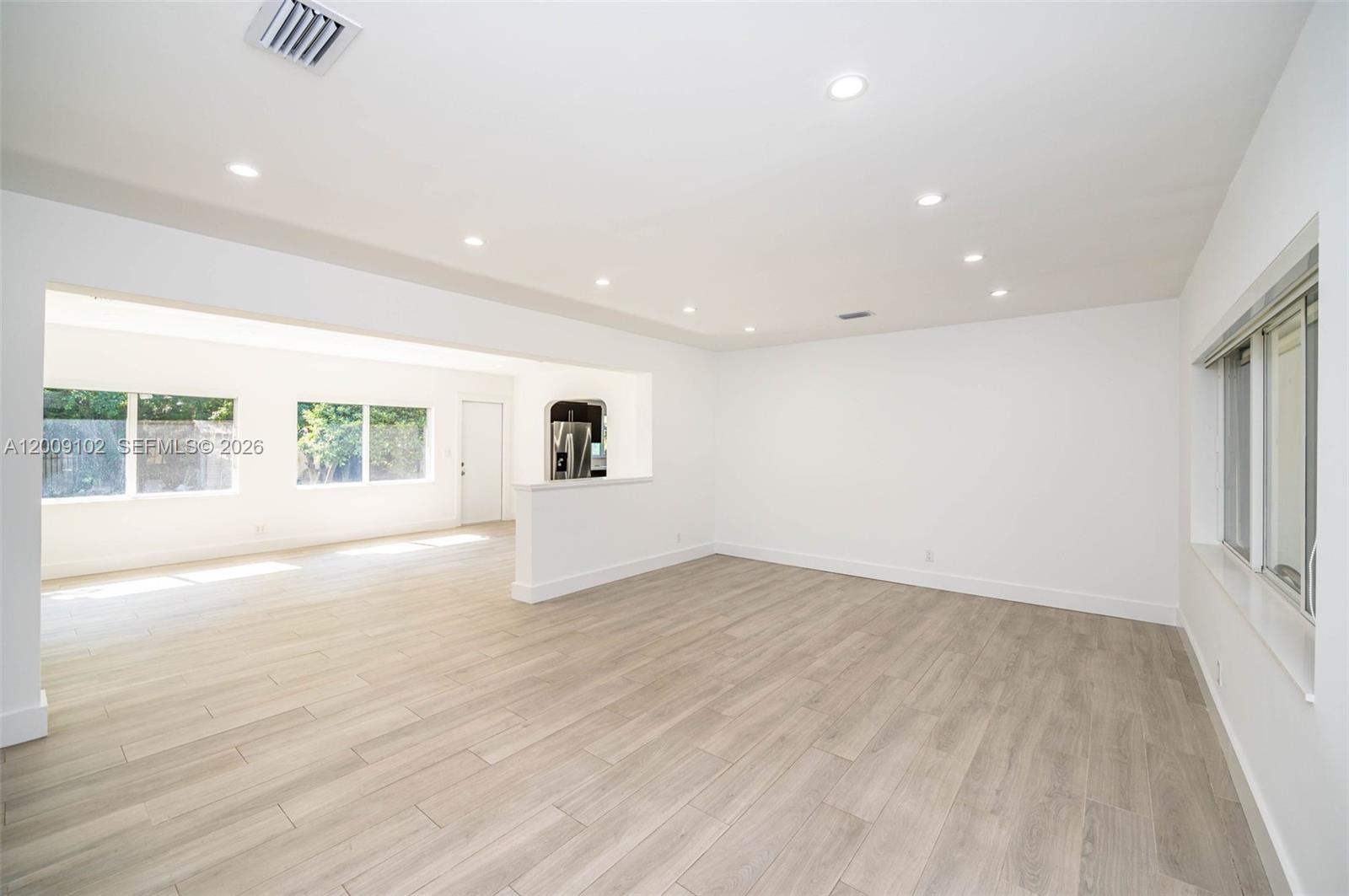 330 Southwest 27th Road Miami, FL 33129 - Photo 7 of 62 an empty room with wooden floor and windows
