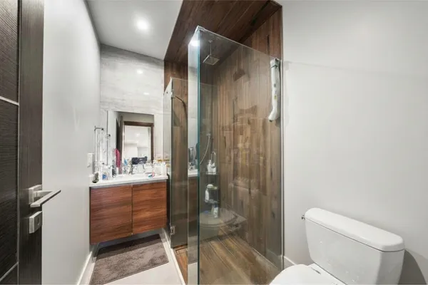 a bathroom with a toilet sink and shower