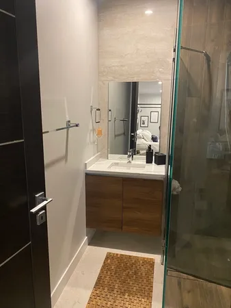 a bathroom with a sink a mirror and a shower