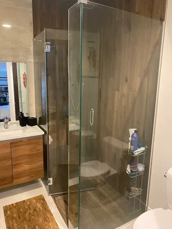 a bathroom with a shower and a sink