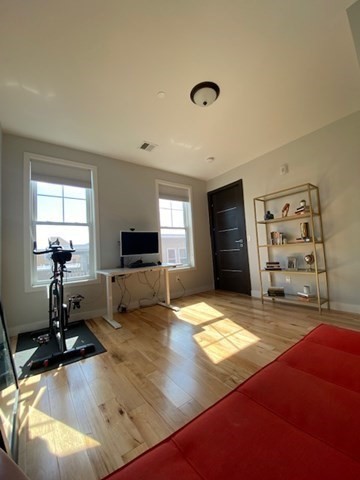 39 Lexington Street, Unit 5 Boston, MA 02128 - Photo 15 of 28 a living room with furniture and a flat screen tv