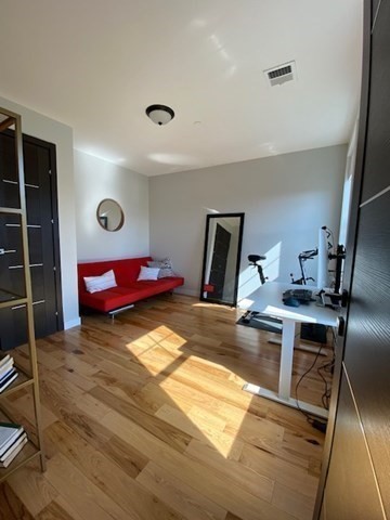 39 Lexington Street, Unit 5 Boston, MA 02128 - Photo 16 of 28 a room with a bed and a mirror