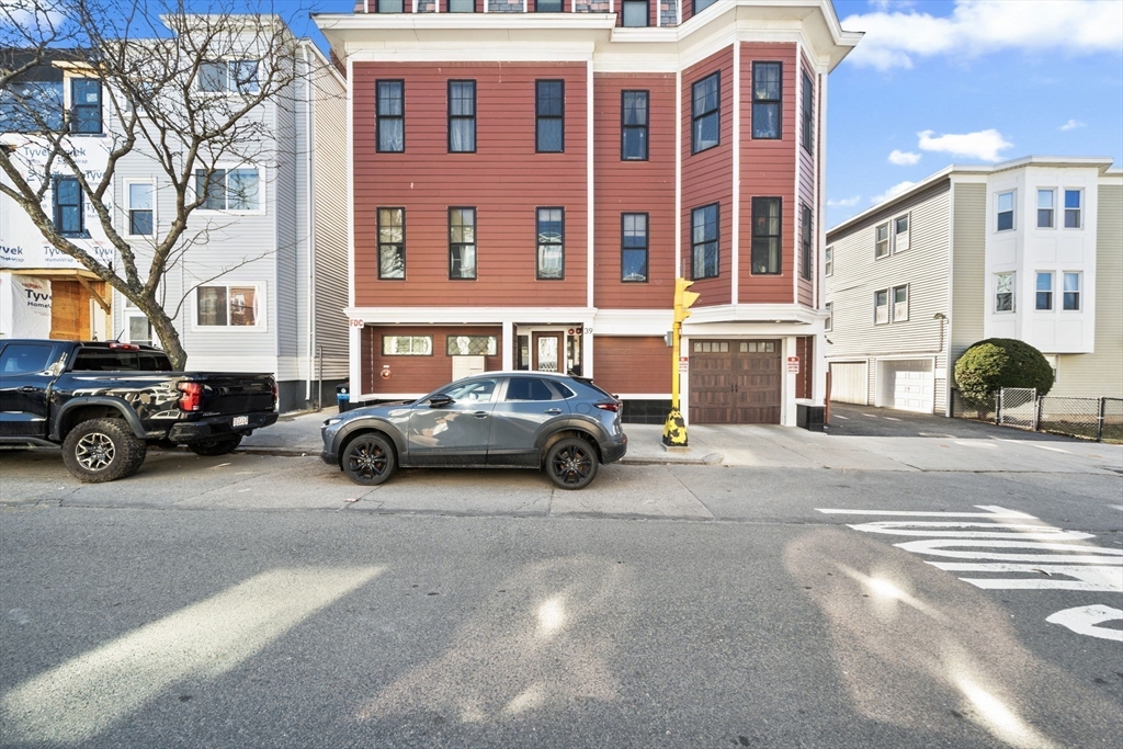 39 Lexington Street, Unit 5 Boston, MA 02128 - Photo 25 of 28 a car parked in front of a building