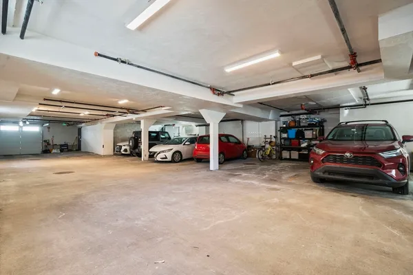 a view of parking garage with cars