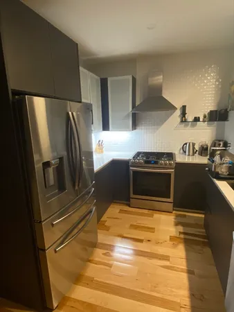 a kitchen with stainless steel appliances a refrigerator and a stove