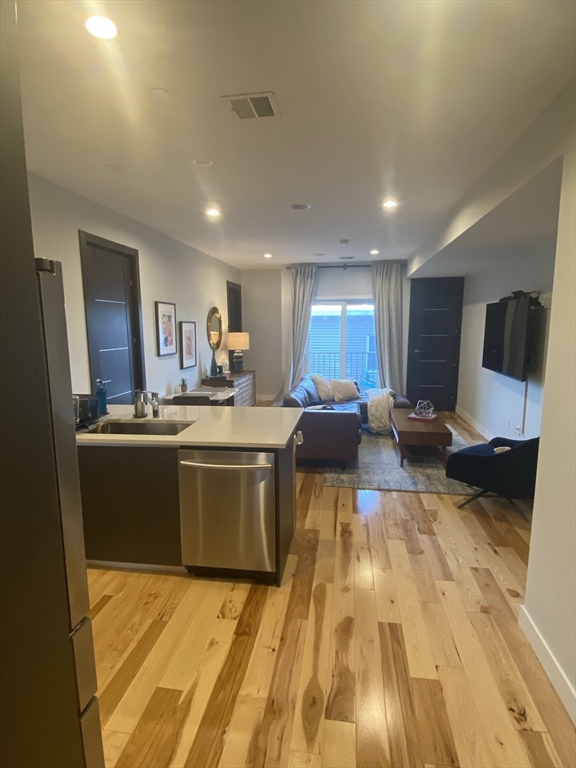 39 Lexington Street, Unit 5 Boston, MA 02128 - Photo 6 of 28 a large kitchen with stainless steel appliances a large counter top a stove and a refrigerator