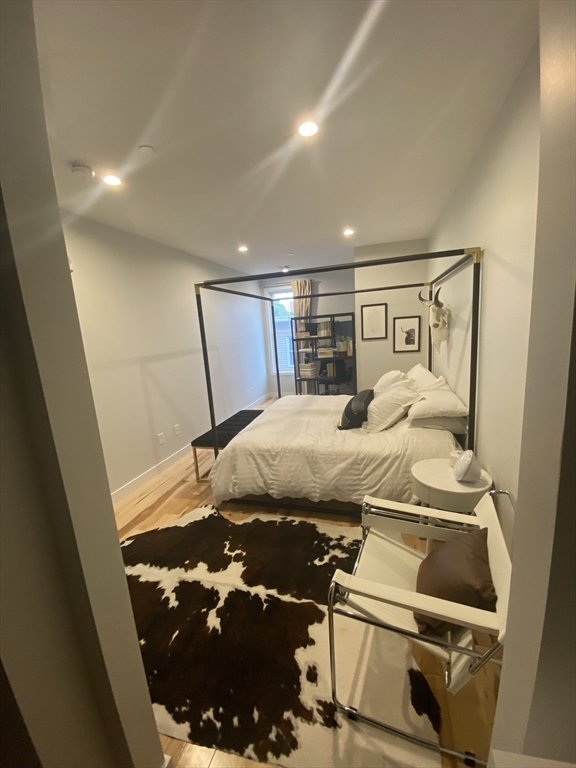 39 Lexington Street, Unit 5 Boston, MA 02128 - Photo 8 of 28 a bed sitting in a bedroom next to a window