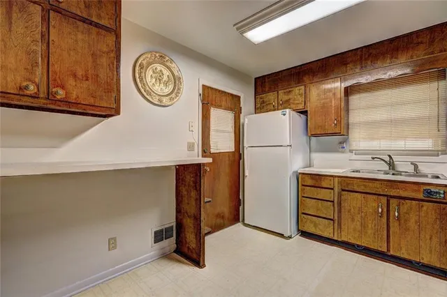 a view of kitchen with stainless steel appliances granite countertop cabinets and a refrigerator