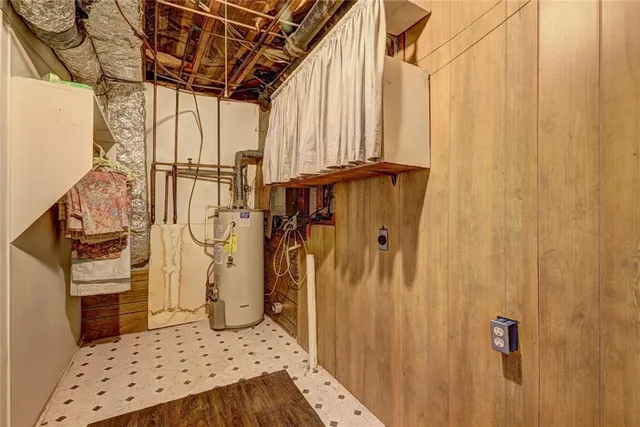 a view of walk in closet with wooden floor