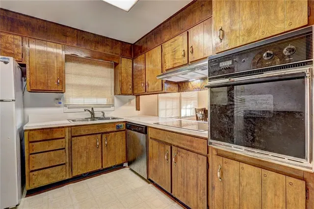 a kitchen with stainless steel appliances granite countertop a sink and cabinets
