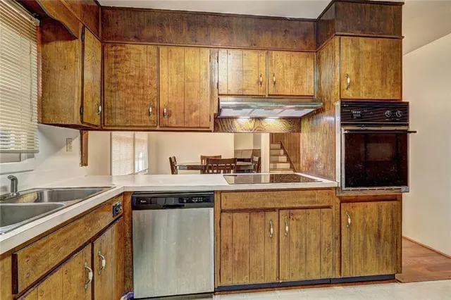 a kitchen with stainless steel appliances granite countertop a sink and a cabinets