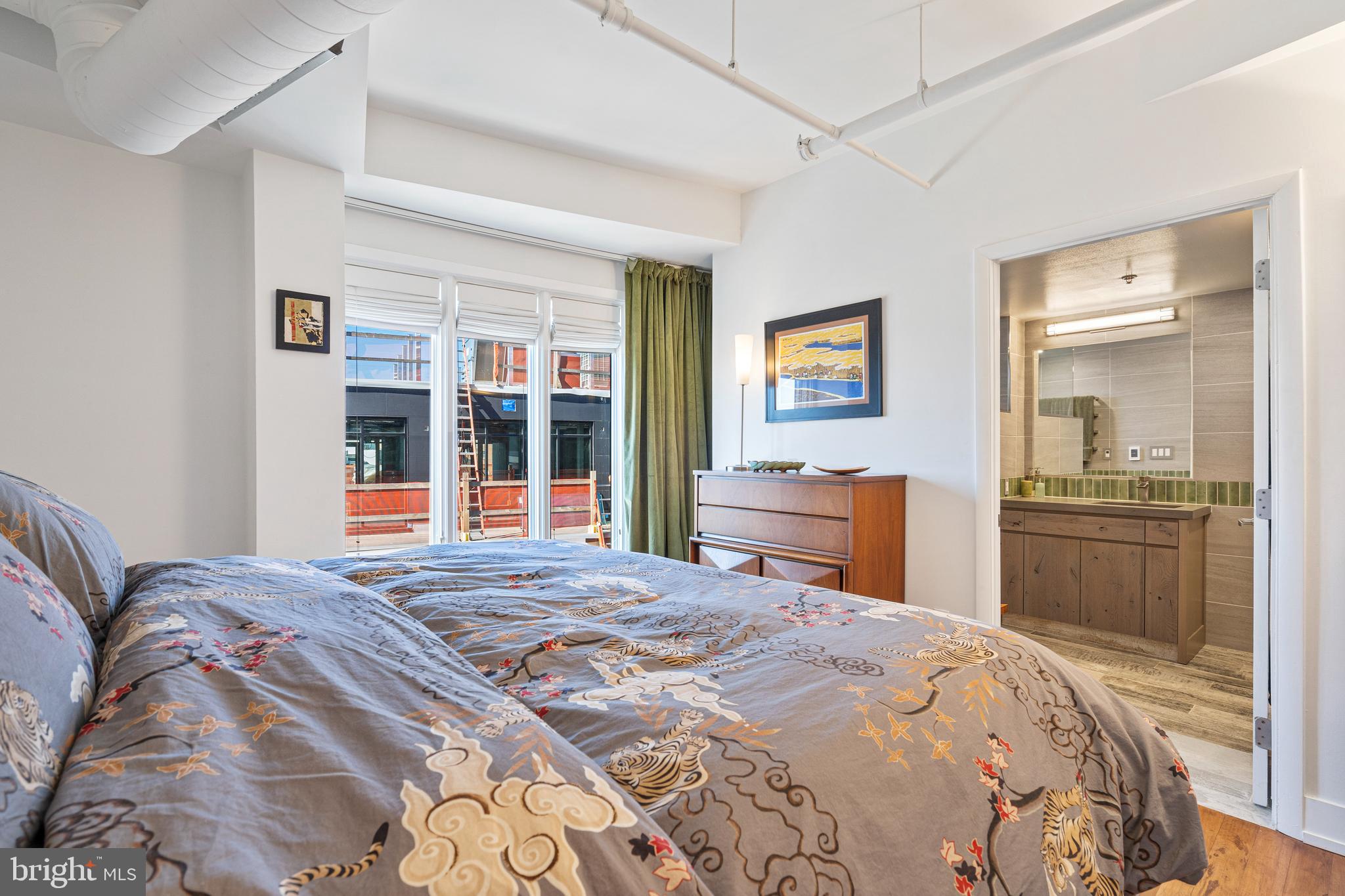 1700 Kalorama Road Northwest, Unit PH502 Washington, DC 20009 - Photo 14 of 50 a bedroom with a bed and a large mirror on the dresser