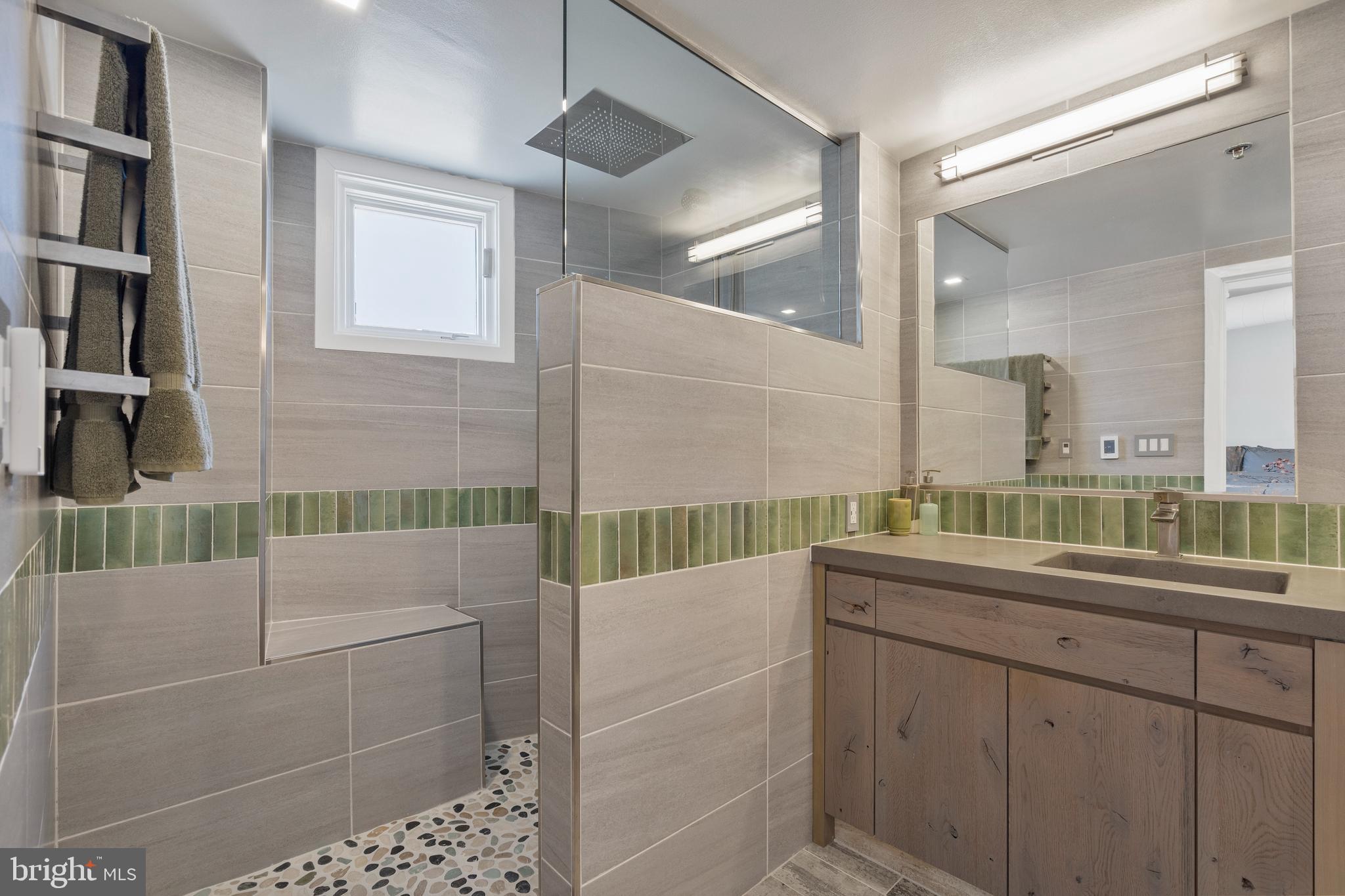 1700 Kalorama Road Northwest, Unit PH502 Washington, DC 20009 - Photo 15 of 50 a bathroom with a shower sink and mirror