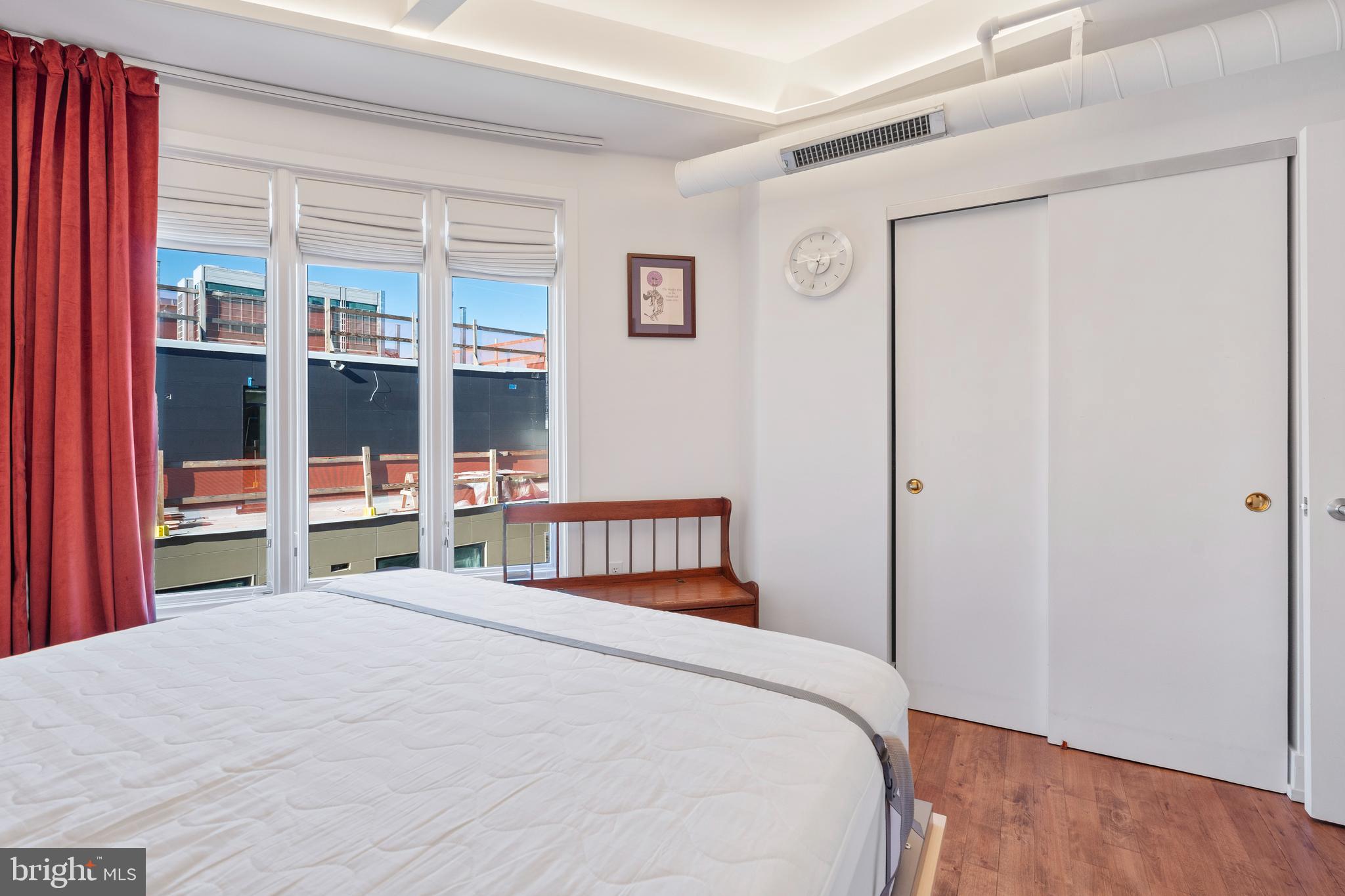 1700 Kalorama Road Northwest, Unit PH502 Washington, DC 20009 - Photo 22 of 50 a bedroom with a bed and a large window