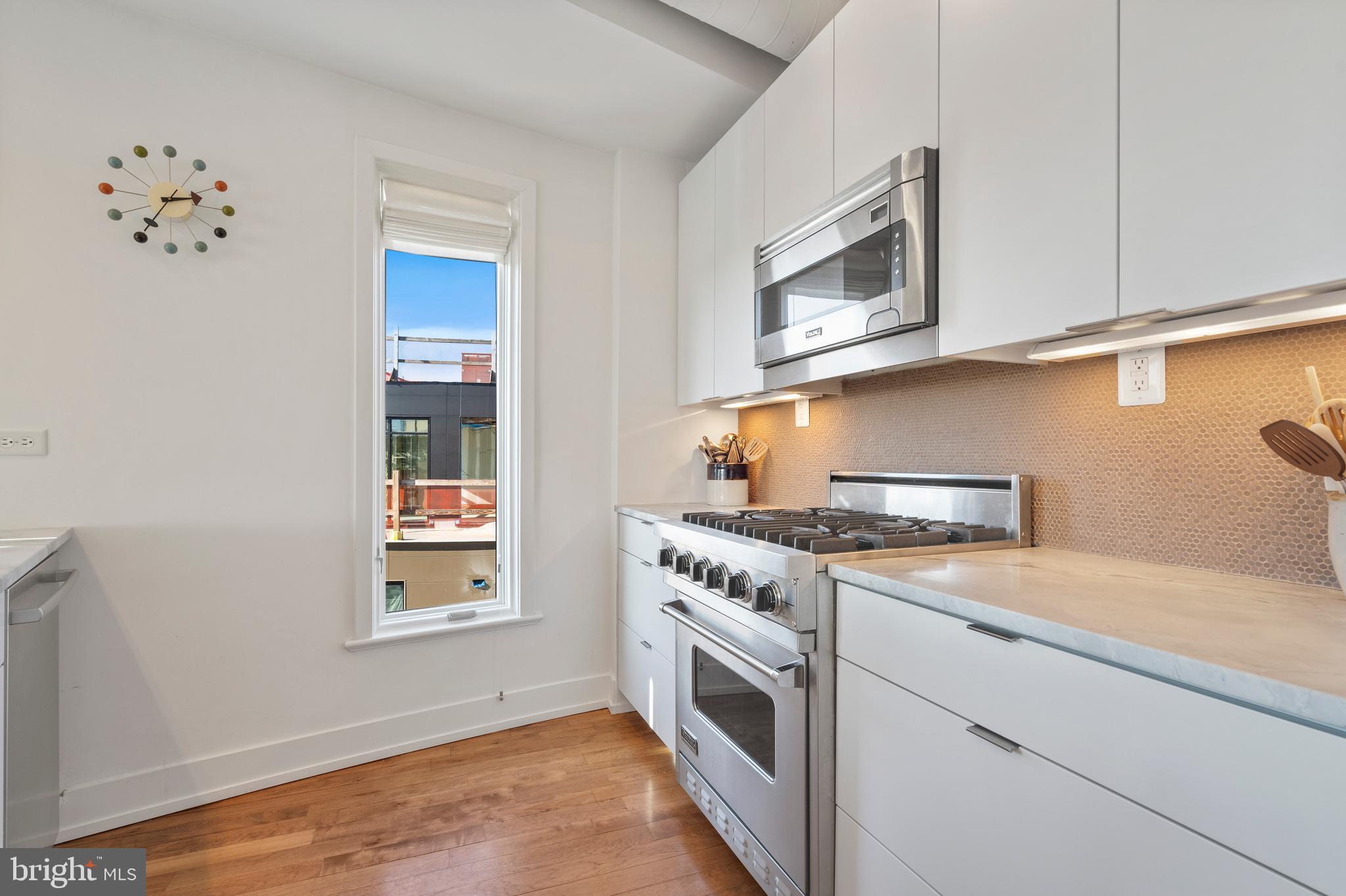 1700 Kalorama Road Northwest, Unit PH502 Washington, DC 20009 - Photo 26 of 50 a kitchen with a stove top oven sink and cabinets