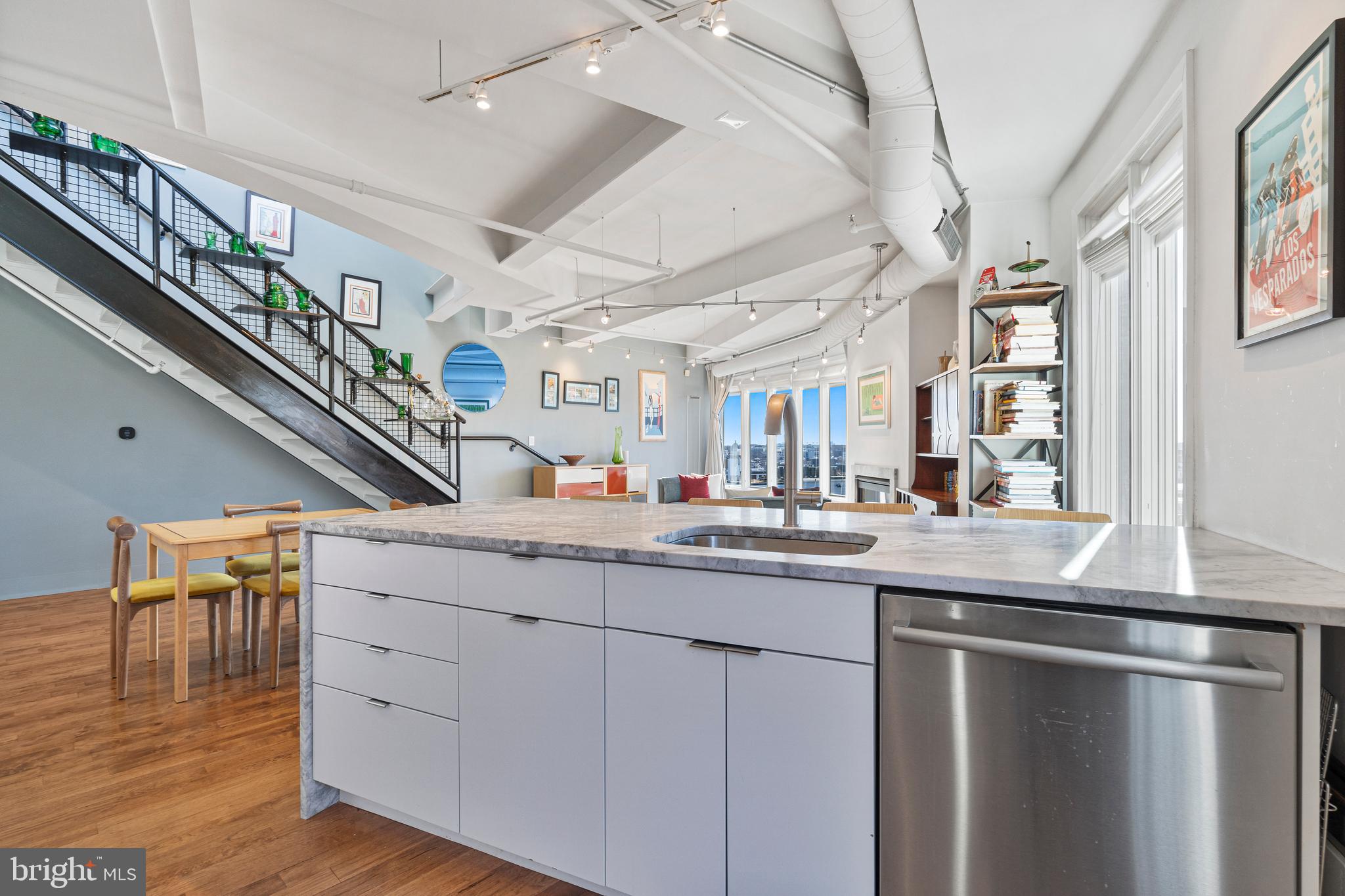 1700 Kalorama Road Northwest, Unit PH502 Washington, DC 20009 - Photo 28 of 50 a kitchen with stainless steel appliances granite countertop a sink and a refrigerator