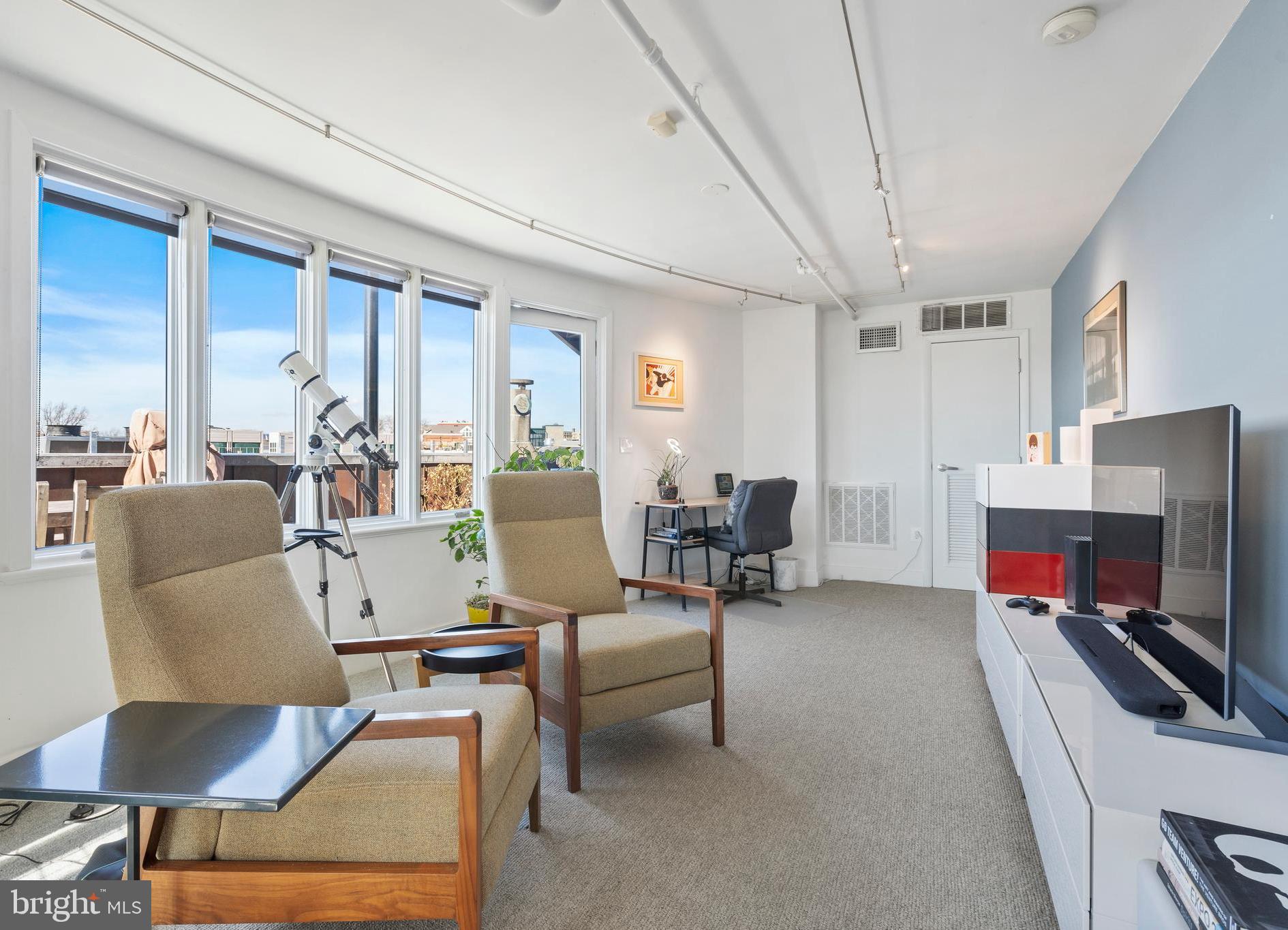 1700 Kalorama Road Northwest, Unit PH502 Washington, DC 20009 - Photo 32 of 50 a living room with furniture and a flat screen tv