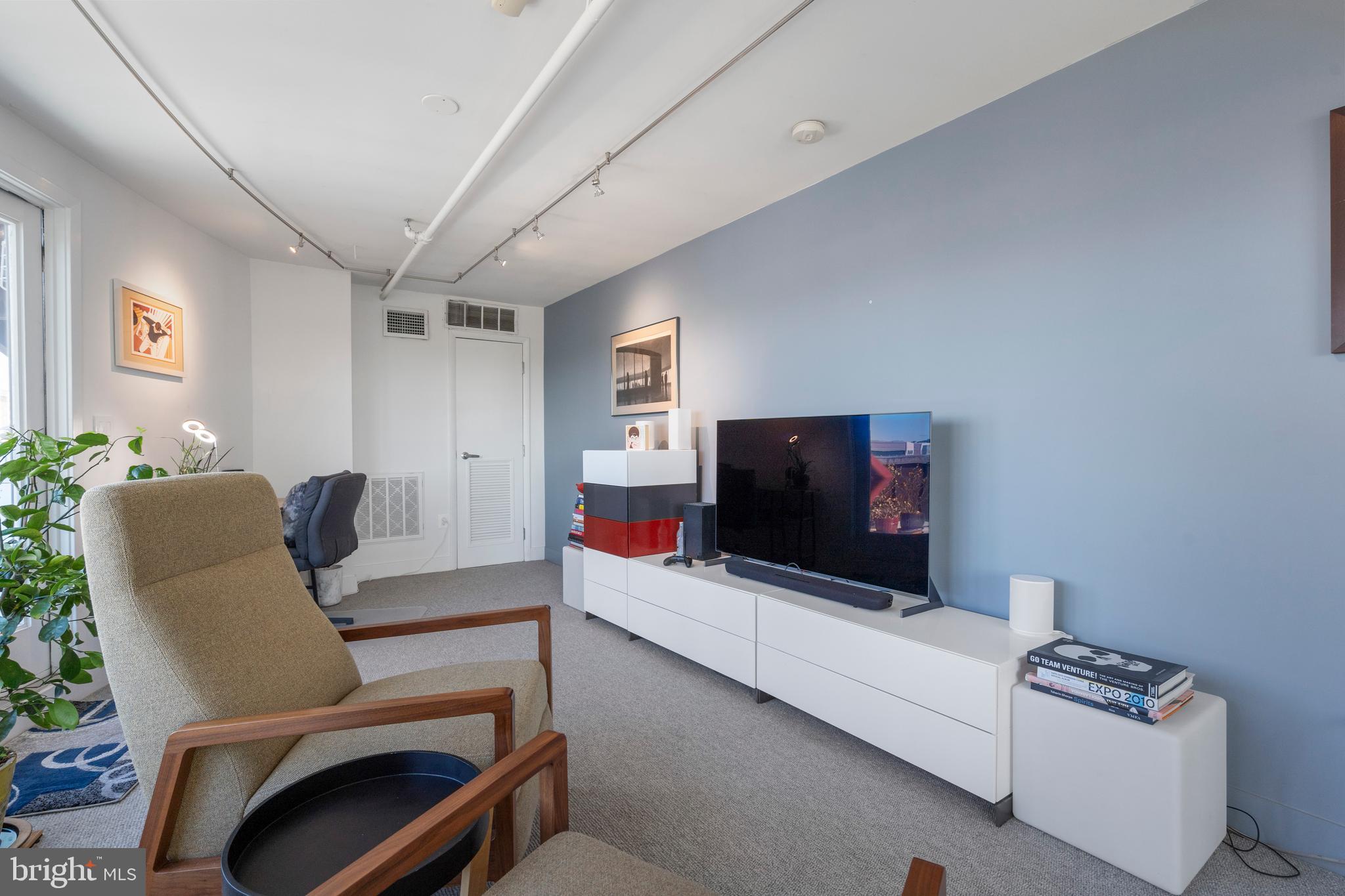 1700 Kalorama Road Northwest, Unit PH502 Washington, DC 20009 - Photo 33 of 50 a living room with furniture and a flat screen tv