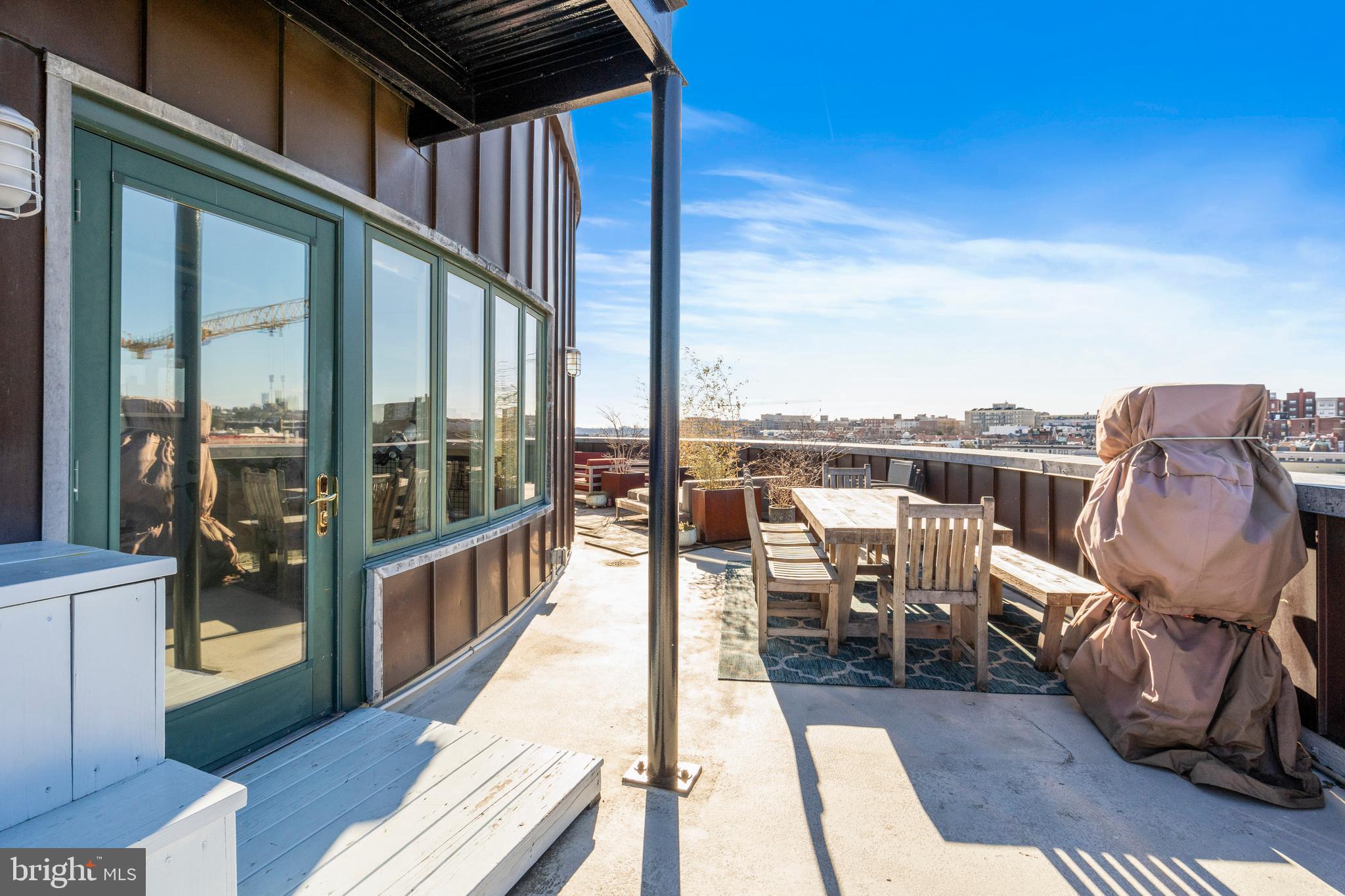 1700 Kalorama Road Northwest, Unit PH502 Washington, DC 20009 - Photo 37 of 50 a view of a balcony with furniture and wooden floor