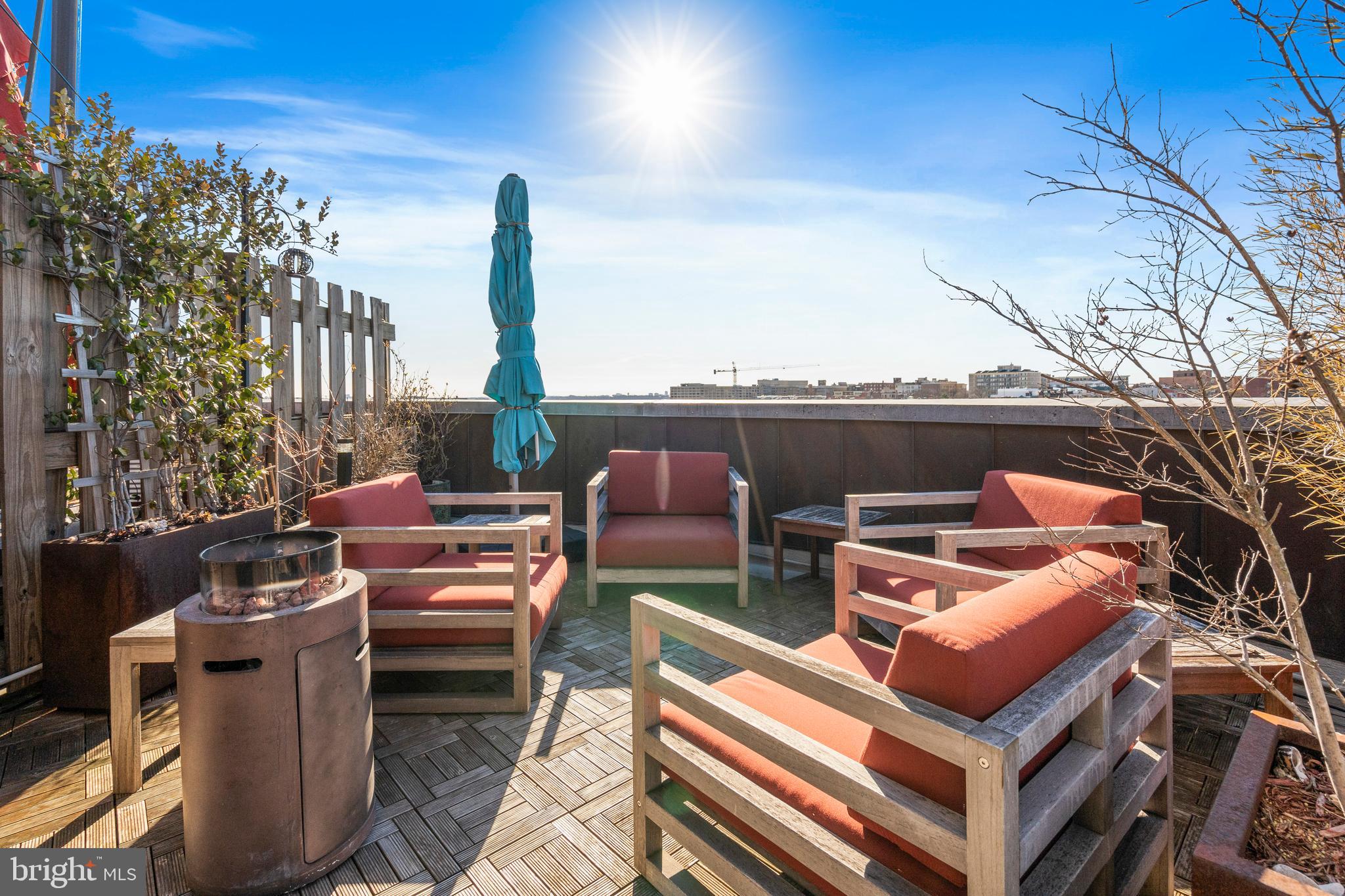 1700 Kalorama Road Northwest, Unit PH502 Washington, DC 20009 - Photo 40 of 50 a roof deck with couches and wooden fence