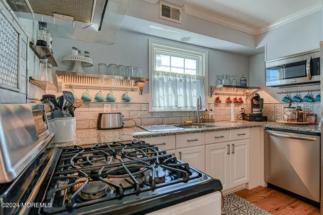 a kitchen with a stove and a sink