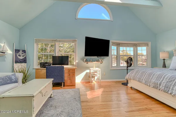 a bedroom with furniture and a flat screen tv