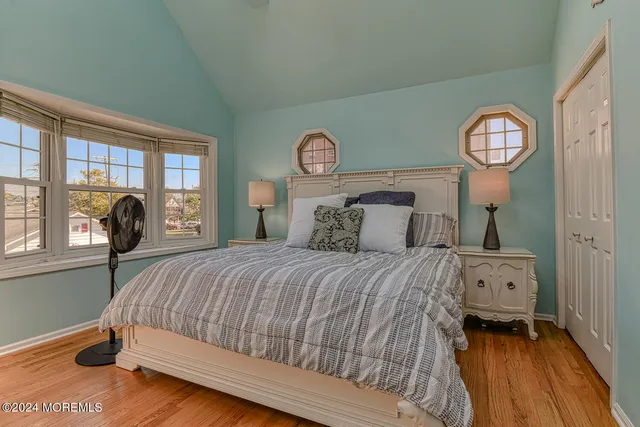 a bedroom with a bed and a large window