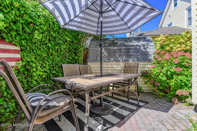 a patio with a table and chairs