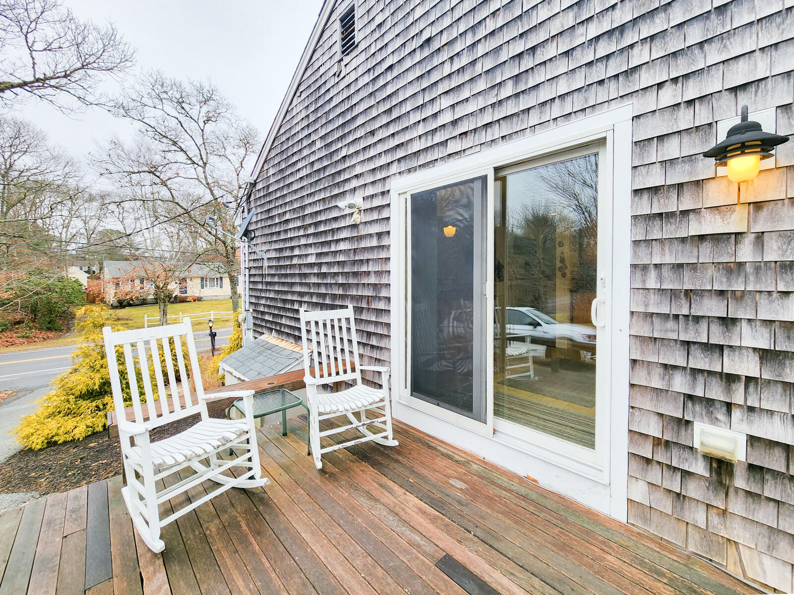 437 Cotuit Road Mashpee, MA 02649 - Photo 18 of 30 a view of a balcony with chairs and wooden floor