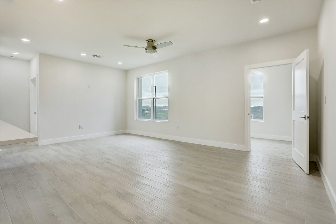 4300 Mansfield Dam Road, Unit 221/230 Austin, TX 78734 - Photo 12 of 32 an empty room with wooden floor and windows