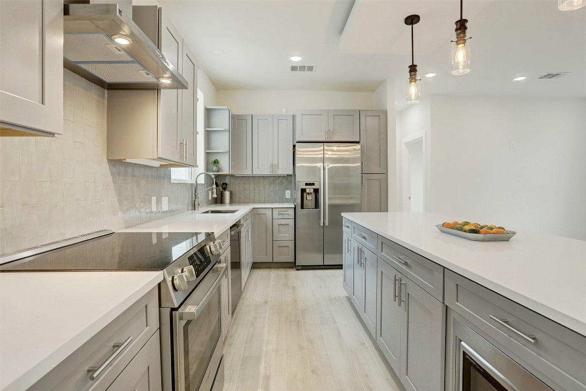 4300 Mansfield Dam Road, Unit 221/230 Austin, TX 78734 - Photo 6 of 32 a kitchen with kitchen island a counter top space a sink stainless steel appliances and cabinets