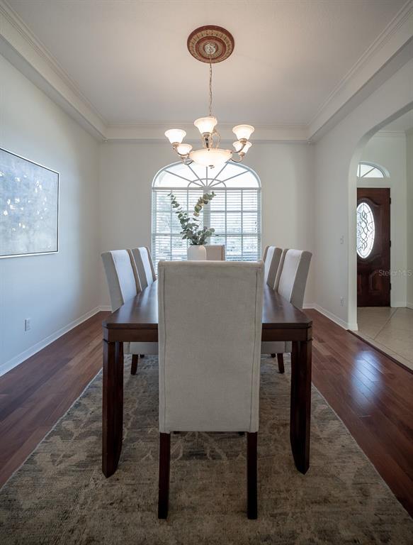 814 Brantenburg Way Lutz, FL 33548 - Photo 14 of 34 a view of a dining room with furniture and wooden floor