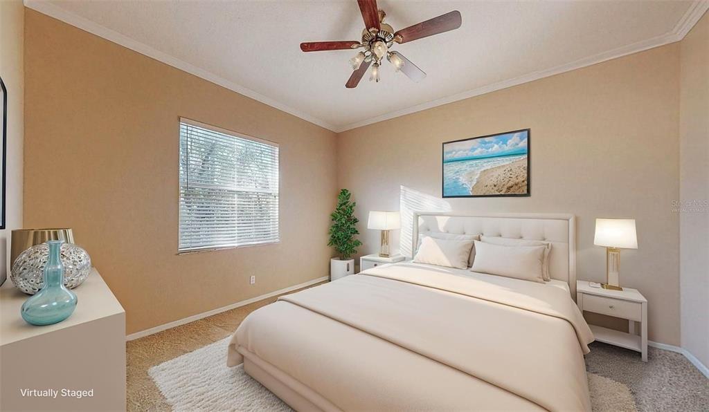 814 Brantenburg Way Lutz, FL 33548 - Photo 22 of 34 a bedroom with a bed and a chandelier