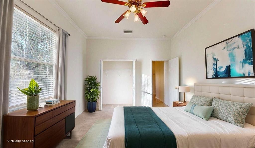 814 Brantenburg Way Lutz, FL 33548 - Photo 27 of 34 a bedroom with a bed and a chandelier