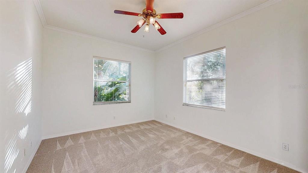 814 Brantenburg Way Lutz, FL 33548 - Photo 28 of 34 a view of an empty room with chandelier fan and a window