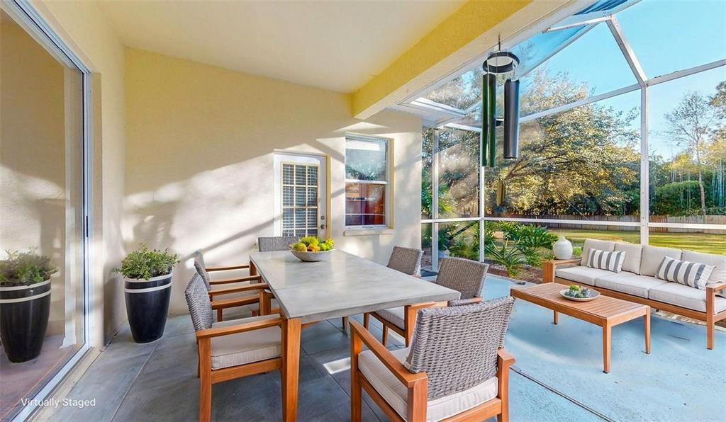 814 Brantenburg Way Lutz, FL 33548 - Photo 31 of 34 a view of deck with a table and chairs potted plants with wooden floor
