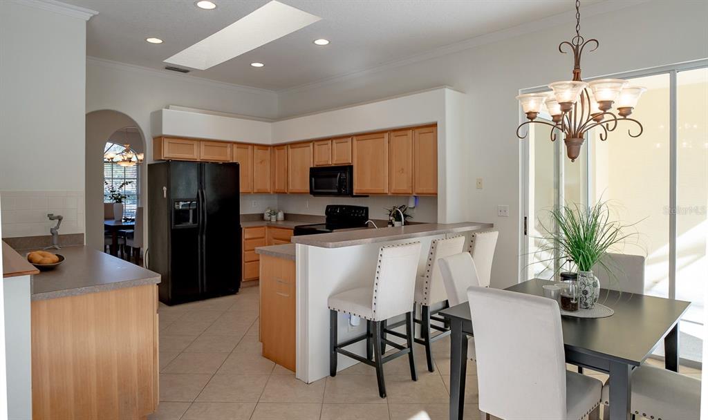 814 Brantenburg Way Lutz, FL 33548 - Photo 10 of 34 a kitchen with stainless steel appliances granite countertop a refrigerator a sink a stove and cabinets