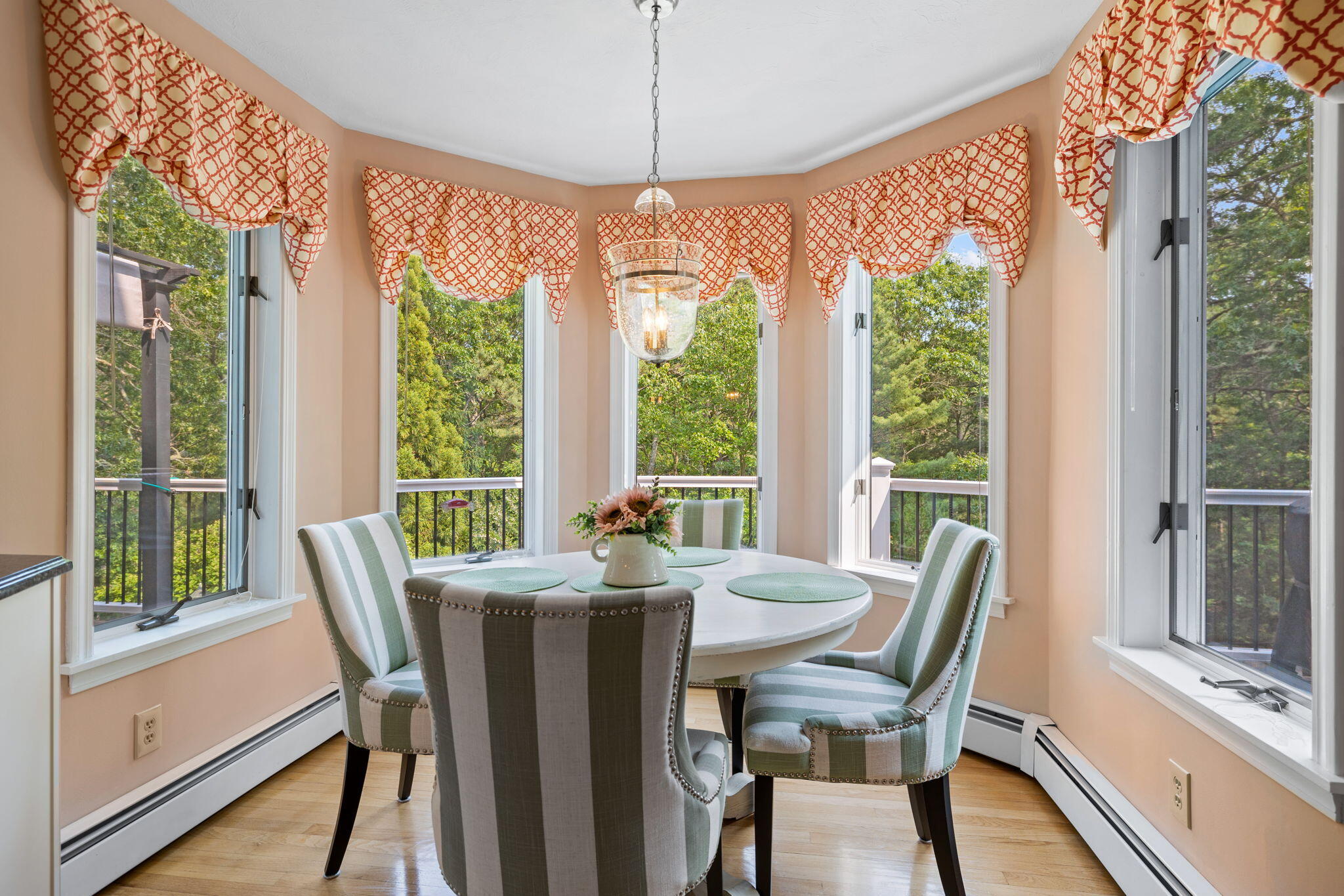 363 Blacksmith Shop Road East Falmouth, MA 02536 - Photo 12 of 40 a view of a dining room with furniture large windows and wooden floor
