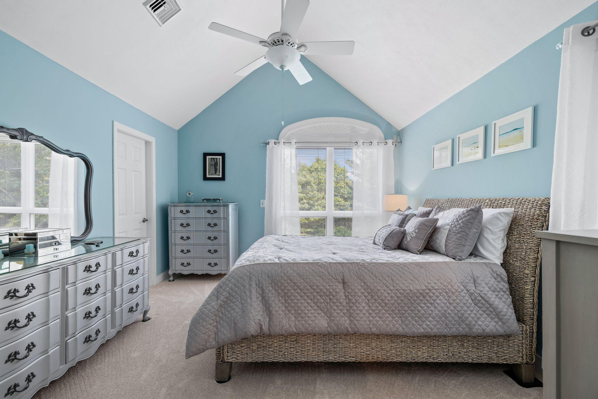363 Blacksmith Shop Road East Falmouth, MA 02536 - Photo 19 of 40 a bedroom with a bed a chandelier and a dresser