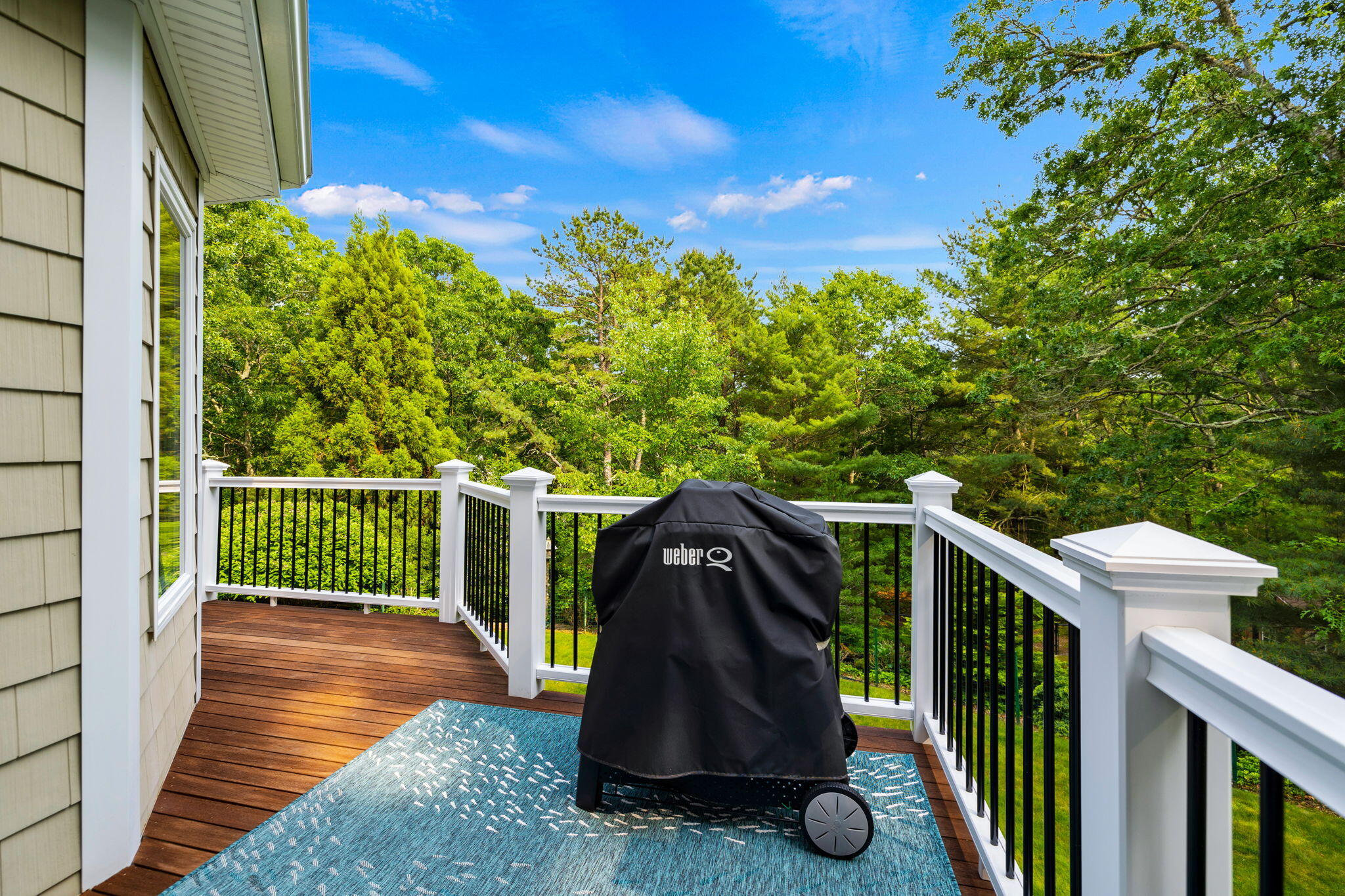 363 Blacksmith Shop Road East Falmouth, MA 02536 - Photo 29 of 40 a view of a deck with a floor to ceiling window and wooden fence