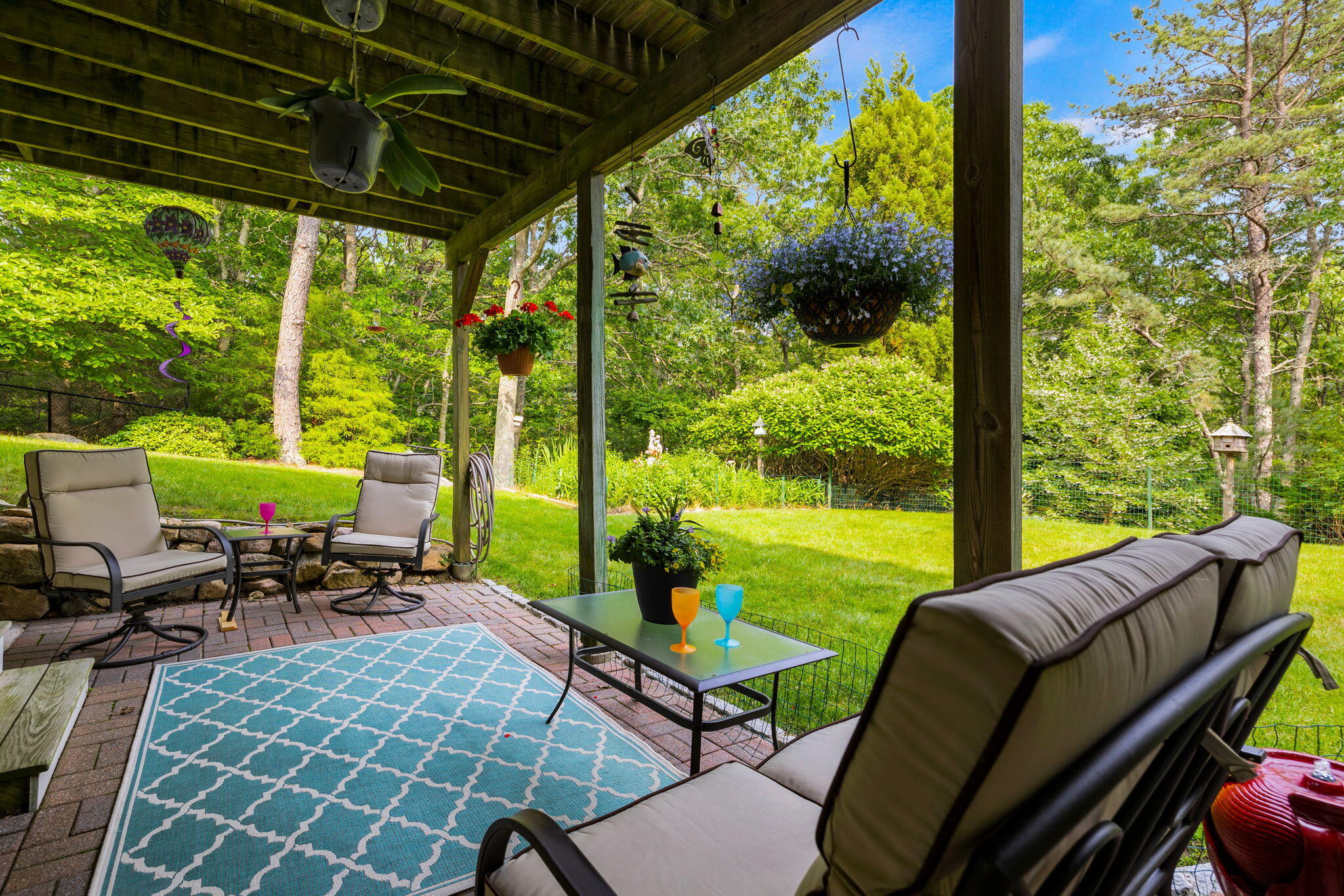 363 Blacksmith Shop Road East Falmouth, MA 02536 - Photo 30 of 40 a view of a patio with chairs and floor to ceiling window backyard