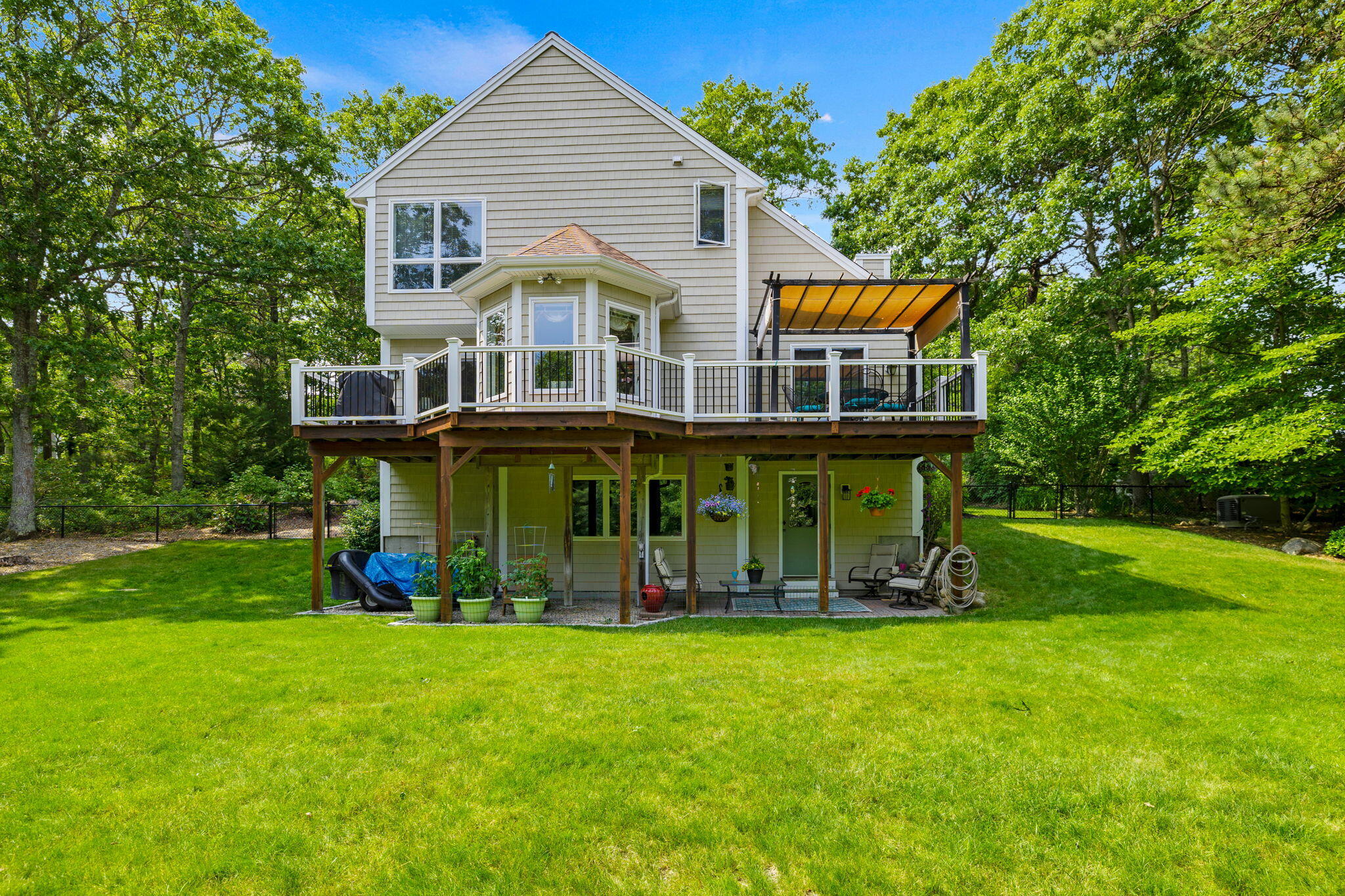 363 Blacksmith Shop Road East Falmouth, MA 02536 - Photo 33 of 40 a view of a house with a yard table and chairs