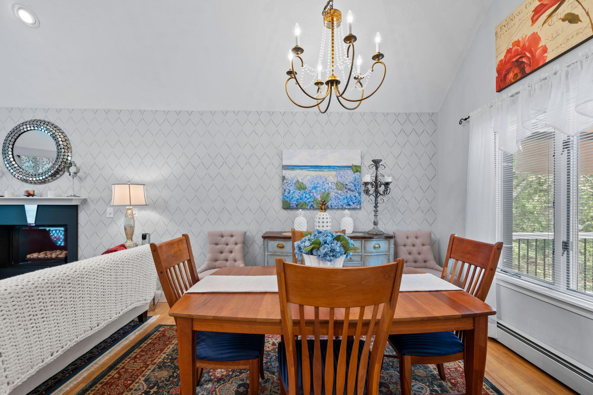 363 Blacksmith Shop Road East Falmouth, MA 02536 - Photo 7 of 40 a dining room with furniture a potted plant and a fireplace