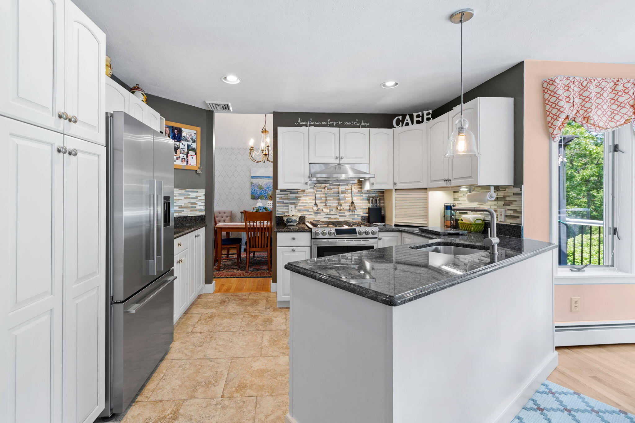 363 Blacksmith Shop Road East Falmouth, MA 02536 - Photo 9 of 40 a kitchen with stainless steel appliances granite countertop a sink a stove a refrigerator and cabinets