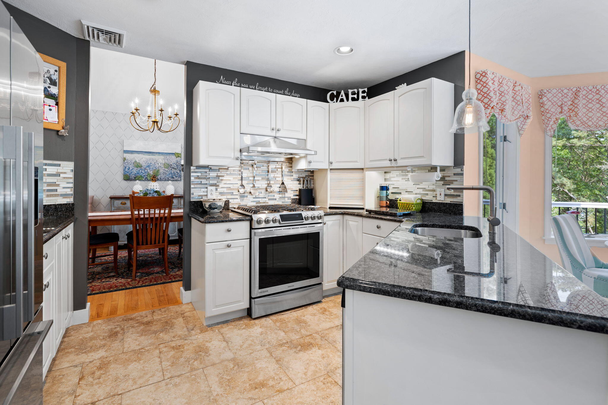 363 Blacksmith Shop Road East Falmouth, MA 02536 - Photo 10 of 40 a kitchen with stainless steel appliances granite countertop a stove a sink and a refrigerator