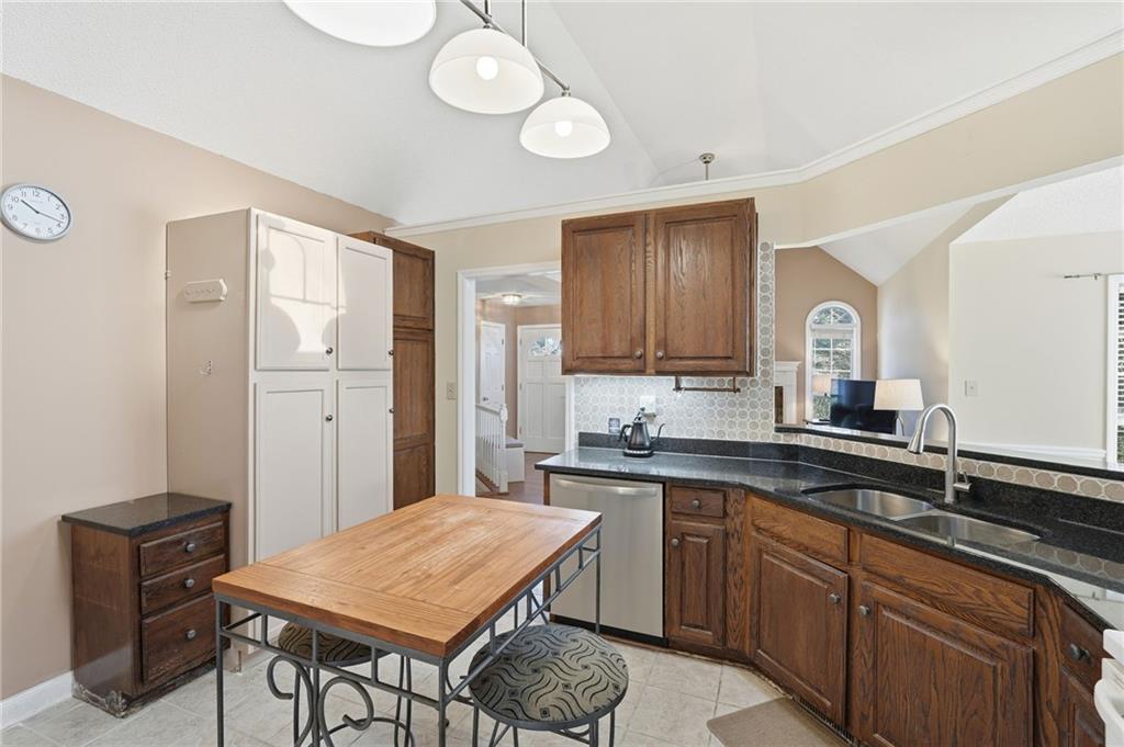 2240 McBrayer Court Cumming, GA 30028 - Photo 12 of 35 a kitchen with a sink cabinets and wooden floor