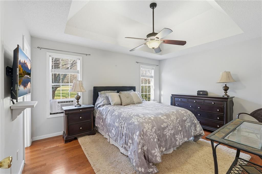 2240 McBrayer Court Cumming, GA 30028 - Photo 15 of 35 a bedroom with a bed and a flat screen tv