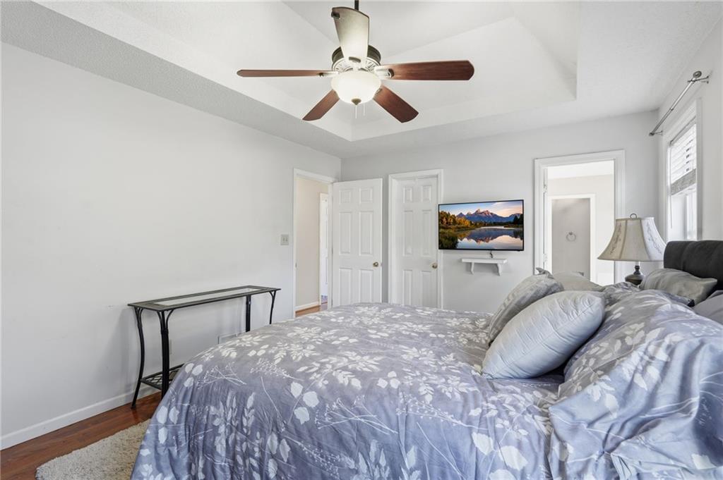 2240 McBrayer Court Cumming, GA 30028 - Photo 16 of 35 a bedroom with a bed and a chandelier